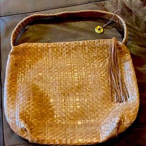 Sak leather woven bag short strap, tassel zipper. 20” strap. Small spot on side.